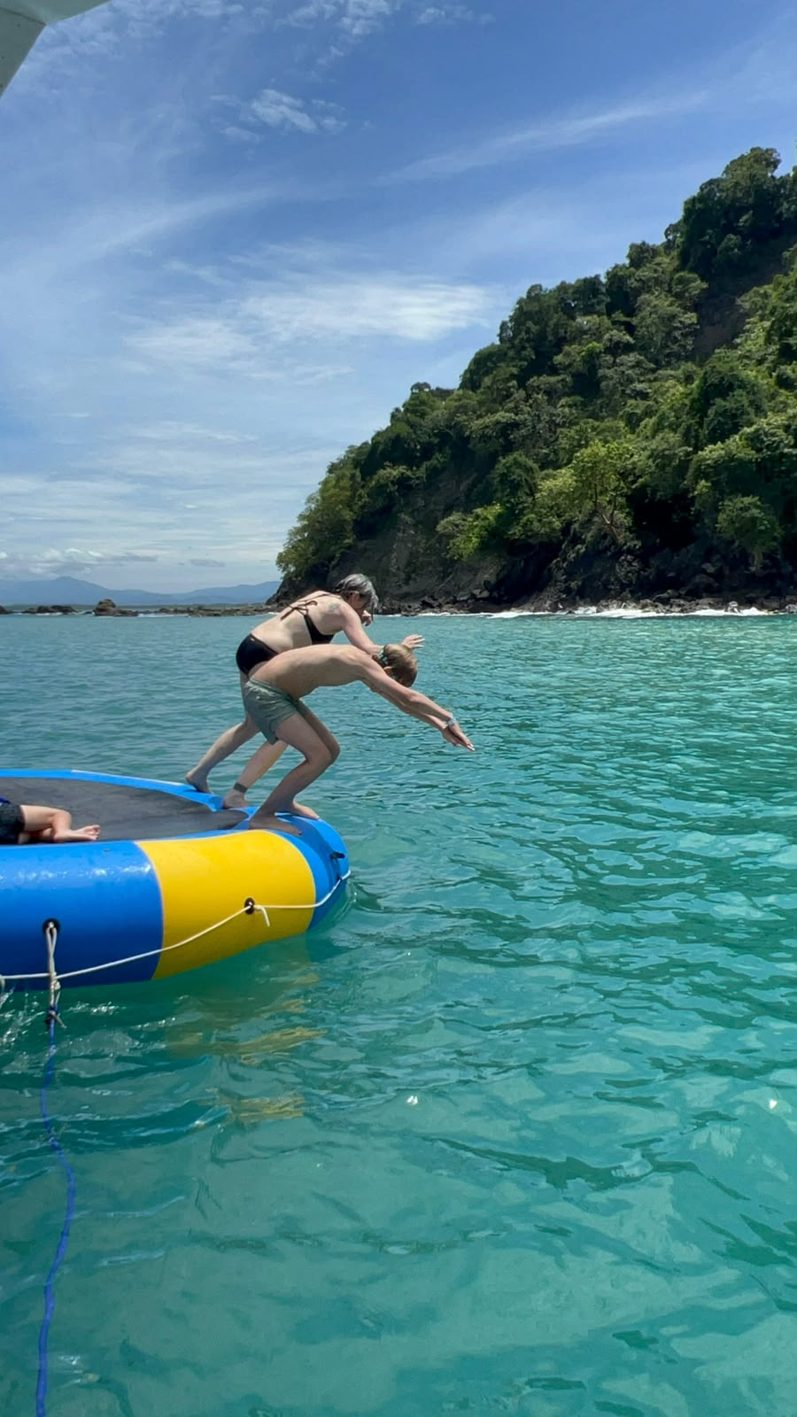 Guest jumping into turquoise water