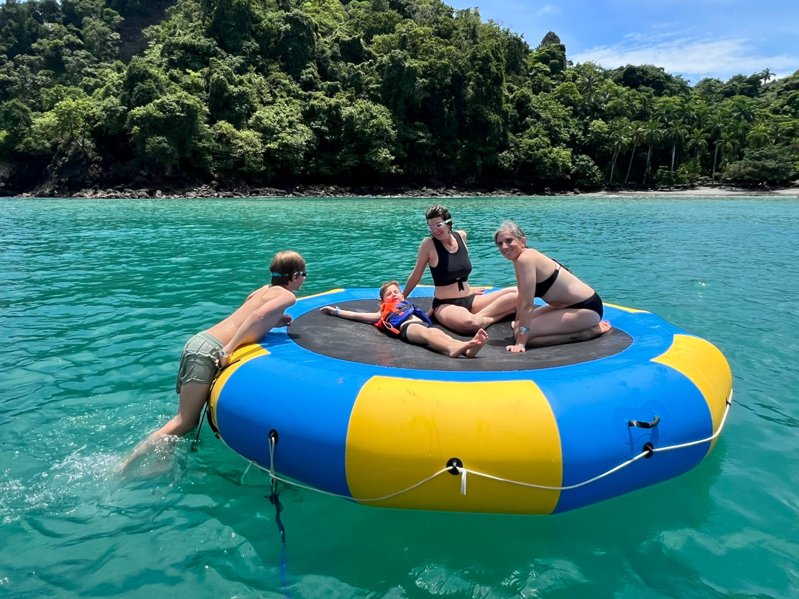 Family on water trampoline in Manuel Antonio